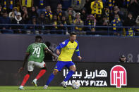 Al Nassr's Cristiano Ronaldo, right, fights for the ball against Al Ettifaq's Abdallah Khateeb during the Saudi Pro League match between Al Nassr and Al Ettifaq at Mrsool Park Stadium, in Riyadh, Saudi Arabia, Sunday, Jan. 22, 2023. (AP Photo)