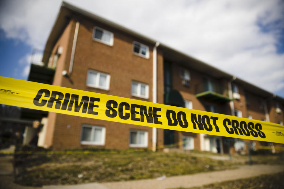 FILE - In this Feb. 26, 2019 file photo, crime scene tape surrounds the Robert Morris Apartments in Morrisville, Pa. Shana Decree and her daughter Dominique Decree who are charged in the killing of their close family members are expected to enter pleas Tuesday, Feb. 18, 2020, in court in Doylestown, Pa. (AP Photo/Matt Rourke, File)