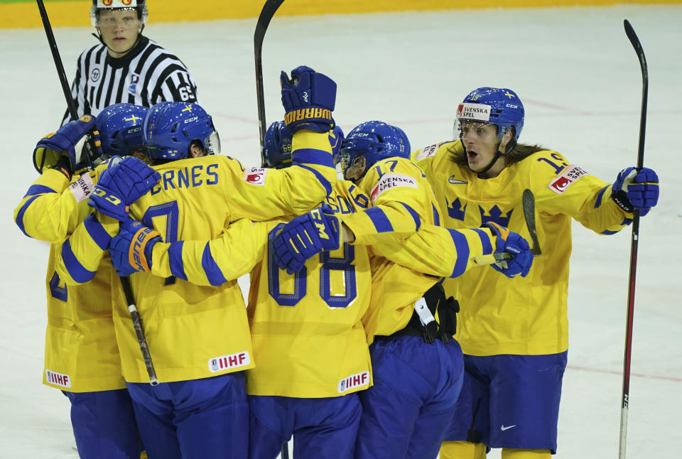 Players of Sweden celebrate during the Ice Hockey World Championship group A match between the Sweden and Slovakia at the Olympic Sports Center in Riga, Latvia, Sunday, May 30, 2021. (AP Photo/Oksana Dzadan)