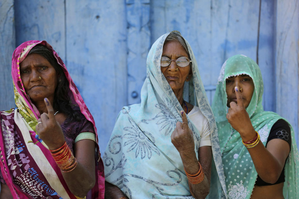 Indian women display the indelible ink marks on their fingers after casting their votes in Karari village, in Kausambi district of Uttar Pradesh state, India, Monday, May 6, 2019. Scattered bomb explosions and clashes between rival political groups marred voting Monday in the crucial fifth phase of India's marathon elections, which also saw Congress party President Rahul Gandhi and his mother, Sonia Gandhi, trying to keep their seats. (AP Photo/Rajesh Kumar Singh)