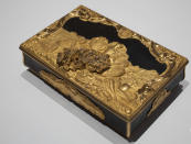 A box gifted to Stadholder William IV as the new governor of the Dutch West India Company (WIC) with decorations referring to the WIC's trade in gold, ivory and people, is displayed at the Slavery exhibition at the Rijksmuseum in Amsterdam, Netherlands, Monday, May 17, 2021. The stark contrast between finery and brutality, wealth and inhumanity is a recurring pattern at the museum's unflinching new exhibition titled, simply, "Slavery", that examines the history of Dutch involvement in the international slave trade. (AP Photo/Peter Dejong)