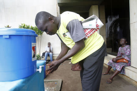 A man washes his hands as a preventive measure against Ebola in Abidjan August 11, 2014. REUTERS/Luc Gnago