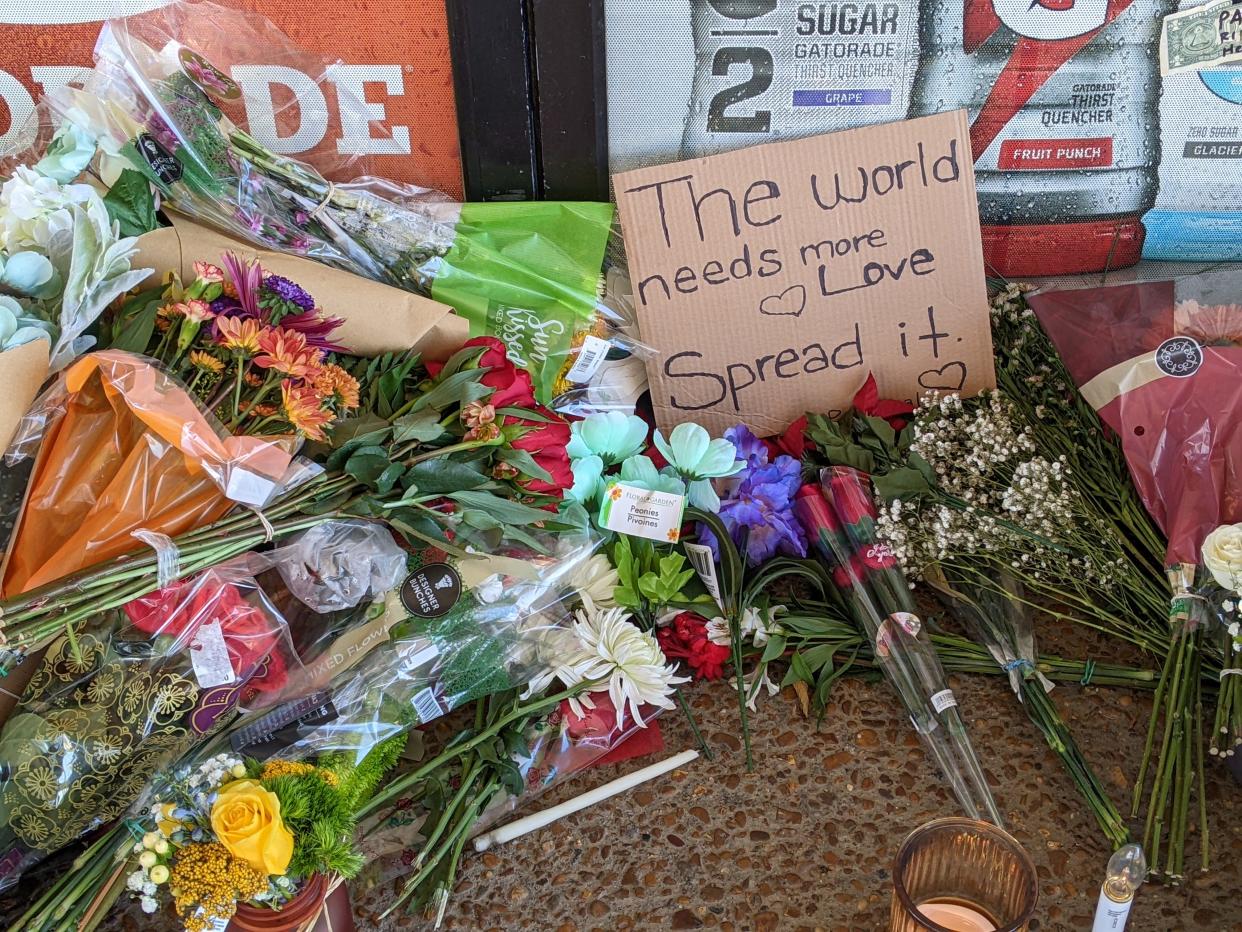 Candles and flowers lay next to the front entrance of the Kwik Sak in Hermitage where Vishal Patel was fatally shot.