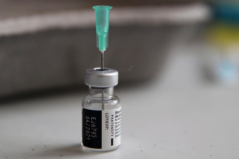 FILE - In this Jan. 18, 2021, file photo, a vial of the Pfizer-BioNTech vaccine against COVID-19 is prepared at a vaccination center of the 3rd district, in Paris. Japan on Sunday, Feb. 14, 2021, formally approved its first COVID-19 vaccine and said it would start nationwide inoculations within days, but months behind the U.S. and many other countries. Japan’s health ministry said it had approved the vaccine co-developed and supplied by Pfizer Inc. (AP Photo/Francois Mori, File)