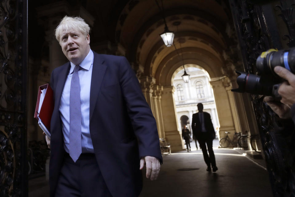 Britain's Prime Minister Boris Johnson returns to Downing Street after attending a Cabinet meeting in London, Tuesday, Oct. 20, 2020. (AP Photo/Kirsty Wigglesworth)