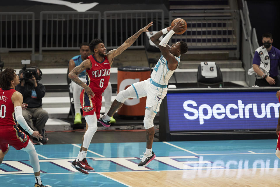 Charlotte Hornets guard Terry Rozier (3) shoots over New Orleans Pelicans guard Nickeil Alexander-Walker (6) during the first half of an NBA basketball game Sunday, May 9, 2021, in Charlotte, N.C. (AP Photo/Brian Westerholt)