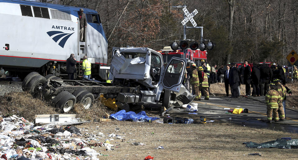 Emergency personnel work at the scene of a train crash involving a garbage truck in Crozet, Va., on Wednesday. (Zack Wajsgrasu/The Daily Progress via AP)