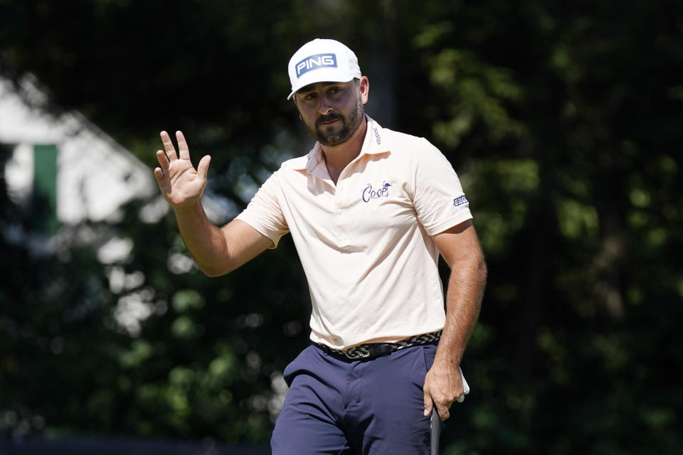 Stephan Jaeger acknowledges the crowd after his birdie putt on the ninth green during the final round of the Rocket Mortgage Classic golf tournament, Sunday, July 31, 2022, in Detroit. (AP Photo/Carlos Osorio)