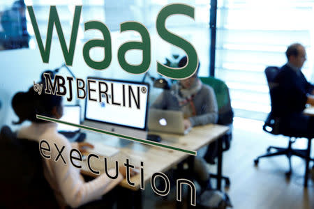 Employees of the "Website as a Service" (WaaS) company MBJ sit in their office in Berlin, Germany October 18, 2016. REUTERS/Axel Schmidt