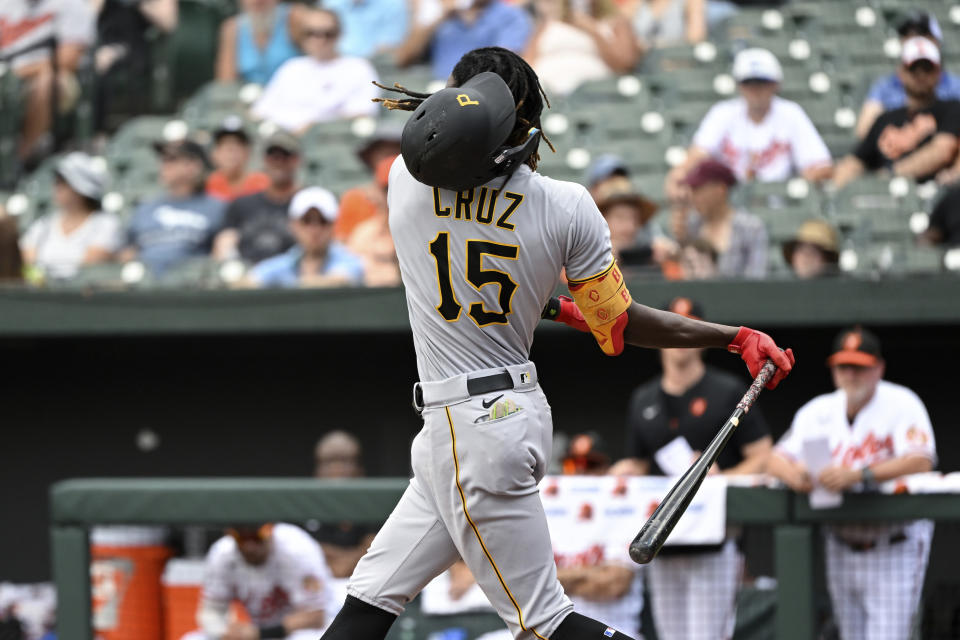 Pittsburgh Pirates' Oneil Cruz (15) swings out of his helmet on a ball thrown by Baltimore Orioles starting pitcher Spenser Watkins during the second inning of a baseball game, Sunday, Aug 7, 2022, in Baltimore. (AP Photo/Terrance Williams)