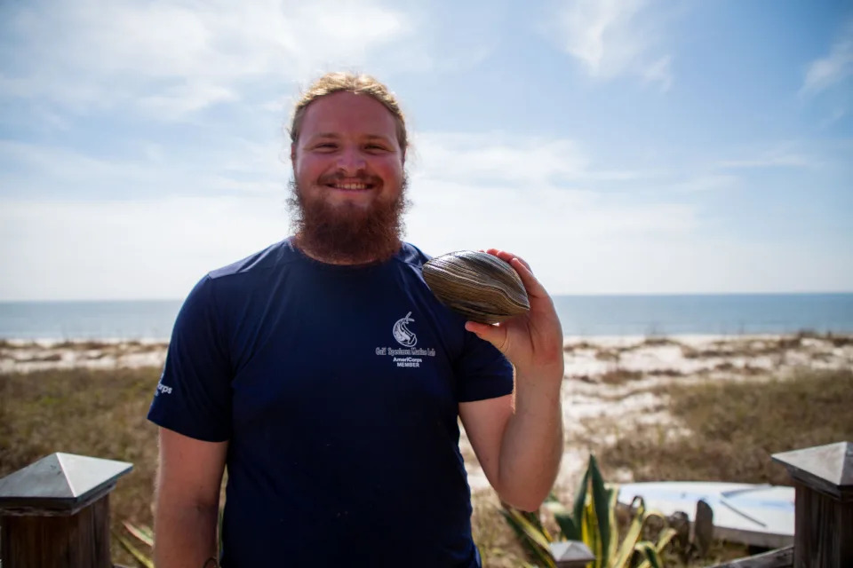 Blaine Parker poses with a quahog clam believed to be 214 years old found at Alligator Point that he found during President’s Day Weekend. 