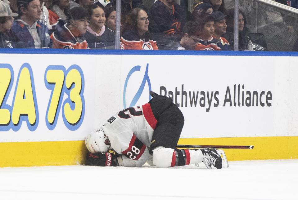 Ottawa Senators' Claude Giroux (28) reacts after being injured during the first period of the team's NHL hockey game against the Edmonton Oilers on Saturday, Jan. 6, 2024, in Edmonton, Alberta. (Jason Franson/The Canadian Press via AP)