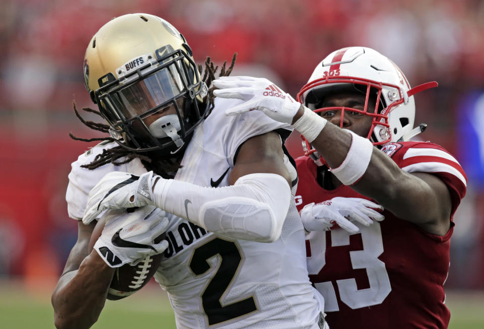 FILE - In this Sept. 8, 2018, file photo, Colorado wide receiver Laviska Shenault Jr. (2) makes a touchdown reception against Nebraska defensive back Dicaprio Bootle (23) during the second half of an NCAA college football game in Lincoln, Neb. Shenault is a shy, soft-spoken person. That is, until he steps onto the field and transforms into an alter ego he's nicknamed "Viska 2Live," becoming an electric playmaker who's vaulted into the conversation for the Heisman Trophy. (AP Photo/Nati Harnik, File)