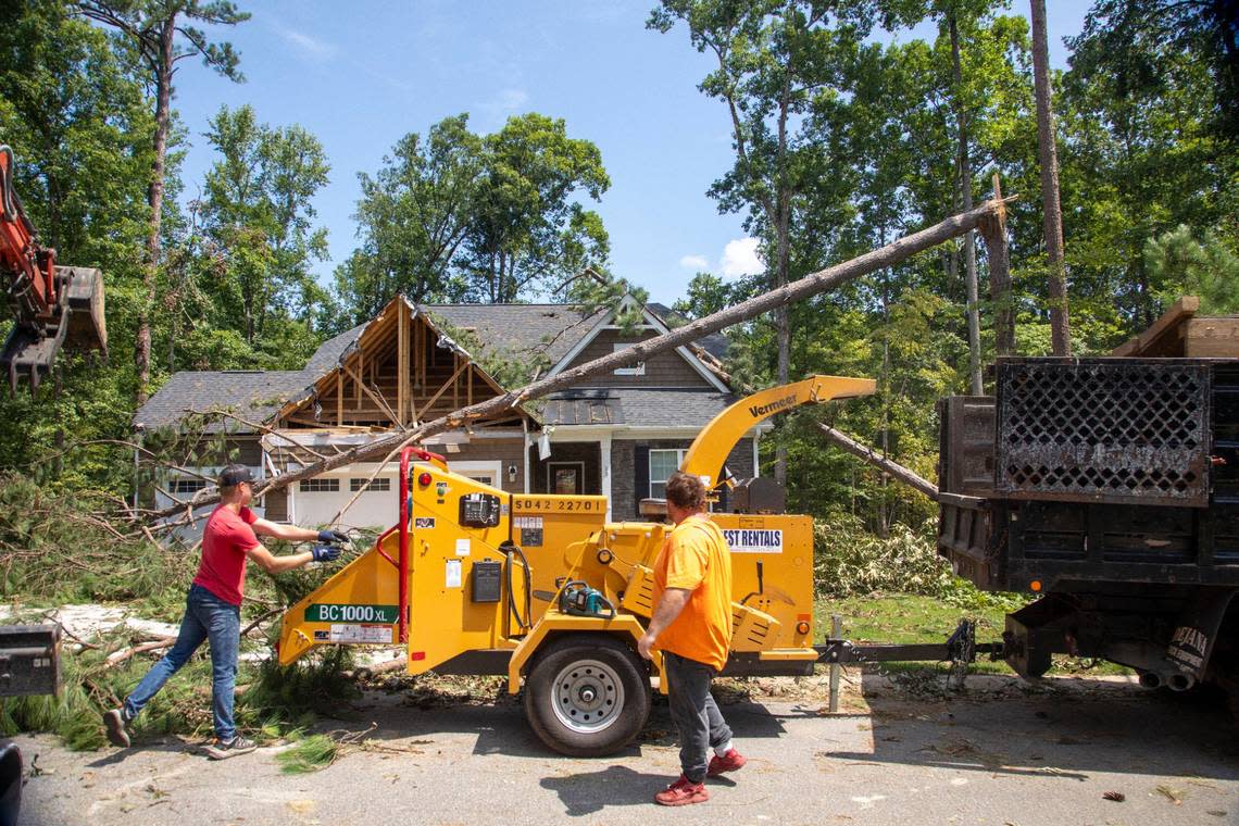 Workers clear debris from a tornado damaged home in the Belmont Lake Golf Club community in Rocky Mount Thursday, July 20, 2023. An EF3, tornado with wind speeds of 150 mph touched down in Nash County Wednesday around 12:30 p.m. Wednesday according to the Raleigh National Weather Service.