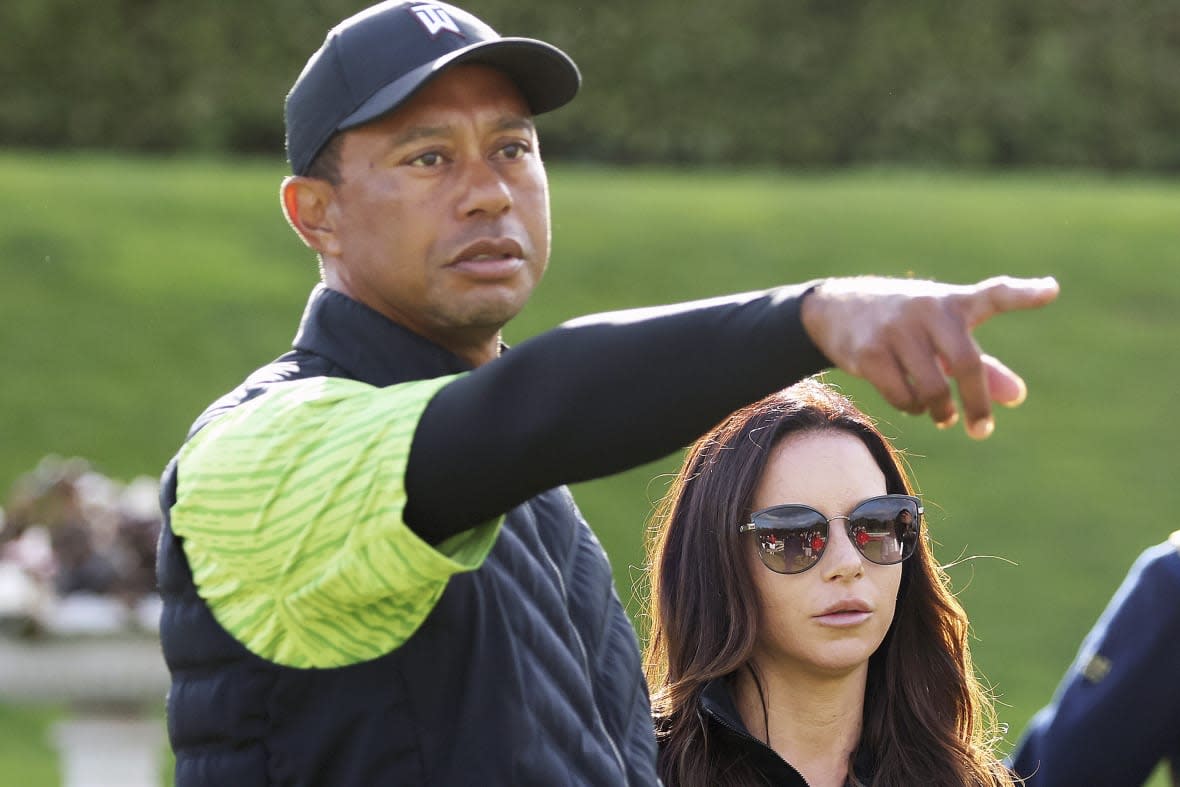 FILE – Tiger Woods and girlfriend Erica Herman on the 18th green during the JP McManus Pro-Am at Adare Manor, Limerick, Ireland, Monday, July, 4, 2022. A $30-million legal battle between Tiger Woods and his ex-girlfriend has escalated with Erica Herman accusing the golf superstar of beginning their sexual relationship when she was his employee and threatening to fire her if she didn’t sign a nondisclosure agreement she now wants voided. (AP Photo/Peter Morrison, FIle)