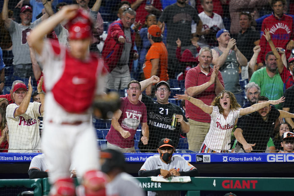 Fans react after Baltimore Orioles' Pedro Severino was tagged out at home by Philadelphia Phillies catcher J.T. Realmuto after trying to score on a single by Pat Valaika during the eighth inning of an interleague baseball game, Wednesday, Sept. 22, 2021, in Philadelphia. (AP Photo/Matt Slocum)