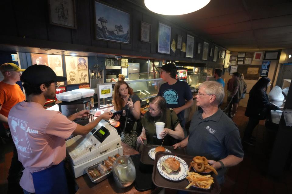 Patrons order burgers at The Chuckbox, a Tempe staple that opened its doors in 1972 on University Drive, on July 8, 2023.