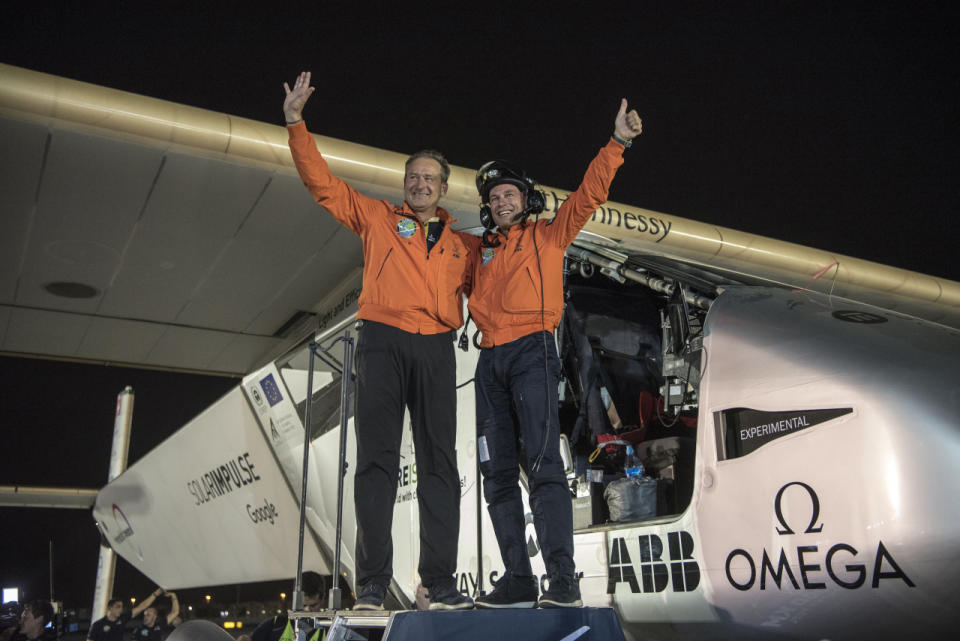 <p>Pilots Bertrrand Piccard and Andre Borschberg celebrate after landing in Abu Dhabi to finish the first around the world flight without the use of fuel. (Solar Impulse/Revillard/Rezo.ch)<br></p>