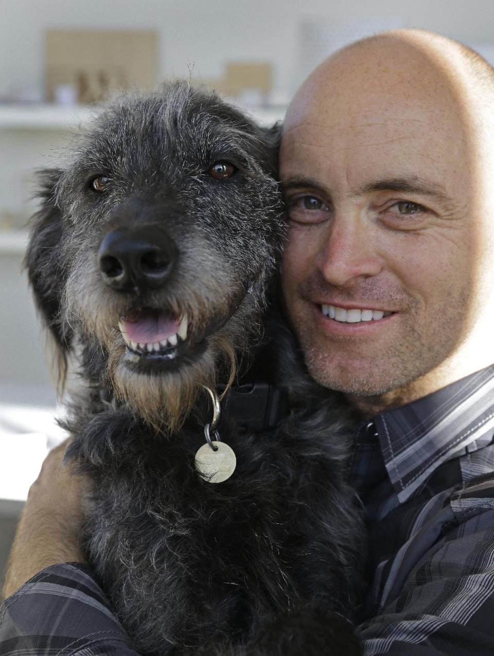 Martin Sprouse with 'Grady', an Airedale Terrier-Irish Wolfhound mix, Thursday, April 18, 2013, in Oakland, Calif. After his owner brought the dog to the Kauai Humane Society because he was moving, the dog with the big brown eyes languished for four months, said shelter operations manager Brandy Varvel. But now Grady is living in a spacious California loft with a new owner who is admittedly smitten thanks to an arrangement the Kauai Humane Society has with the East Bay SPCA in Oakland. (AP Photo/Ben Margot)