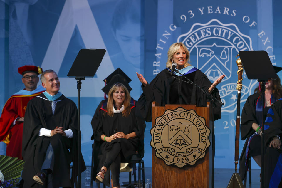 Los Angeles Mayor Eric Garcetti, second from left, looks on as first lady Jill Biden speaks at the Los Angeles City College commencement ceremony in Los Angeles, Tuesday, June 7, 2022. (AP Photo/Ringo H.W. Chiu)