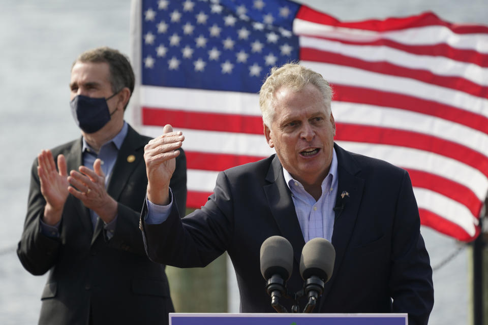 FILE - In this April 8, 2021 file photo, former Virginia Gov. Terry McAuliffe, right, gestures during a news conference with Virginia Gov.Ralph Northam, left, at Waterside in Norfolk, Va. McAuliffe won Virginia's 2013 governor's race by embracing his own brand of personal politics that rely on decades-old friendships, back-slapping charisma and tell-it-like-it-is authenticity. (AP Photo/Steve Helber, File)