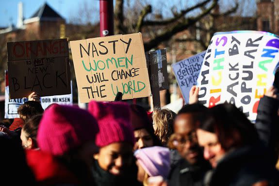 AMSTERDAM, NETHERLANDS - JANUARY 21: Demonstrators with a sign saying "Nasty Women will Change the World " make their way from the iamsterdam statue in front of the Rijksmuseum towards US Consulate during the Women's March held at Museumplein on January 21, 2017 in Amsterdam, Netherlands. The Women's March originated in Washington DC but soon spread to be a global march calling on all concerned citizens to stand up for equality, diversity and inclusion and for women's rights to be recognised around the world as human rights. Global marches are now being held, on the same day, across seven continents. (Photo by Dean Mouhtaropoulos/Getty Images)