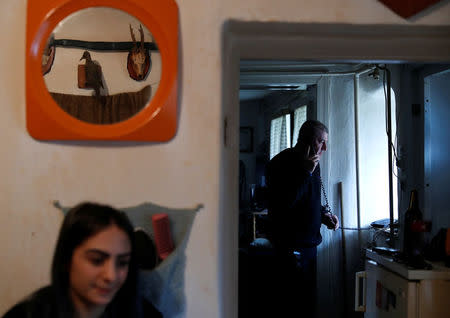 Laszlo Reisch, 48, speaks on the phone at home in Hosszuheteny, Hungary, March 26, 2018. Picture taken March 26, 2018. REUTERS/Bernadett Szabo