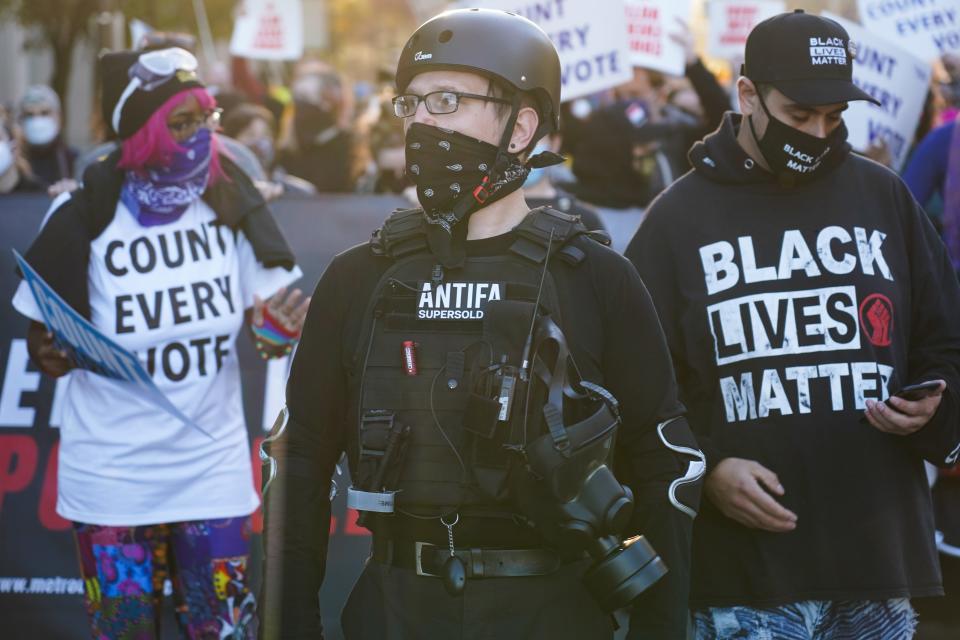 A man with an Antifa badge walks with Detroit Detroit Will Breathe members and other organizations as they march through the city of Detroit on Wednesday, November 4, 2020 while demanding the counting of all votes for the 2020 elections. 