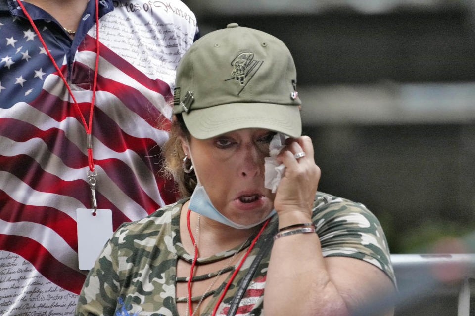 A family member gets emotional at the Tunnel to Towers ceremony, Sept. 11, 2020, in New York. Vice President Mike Pence and his wife Karen will attend the ceremony where the names of nearly 3,000 victims of the Sept. 11, 2001 terror attacks will be read by family members. (AP Photo/Mark Lennihan)