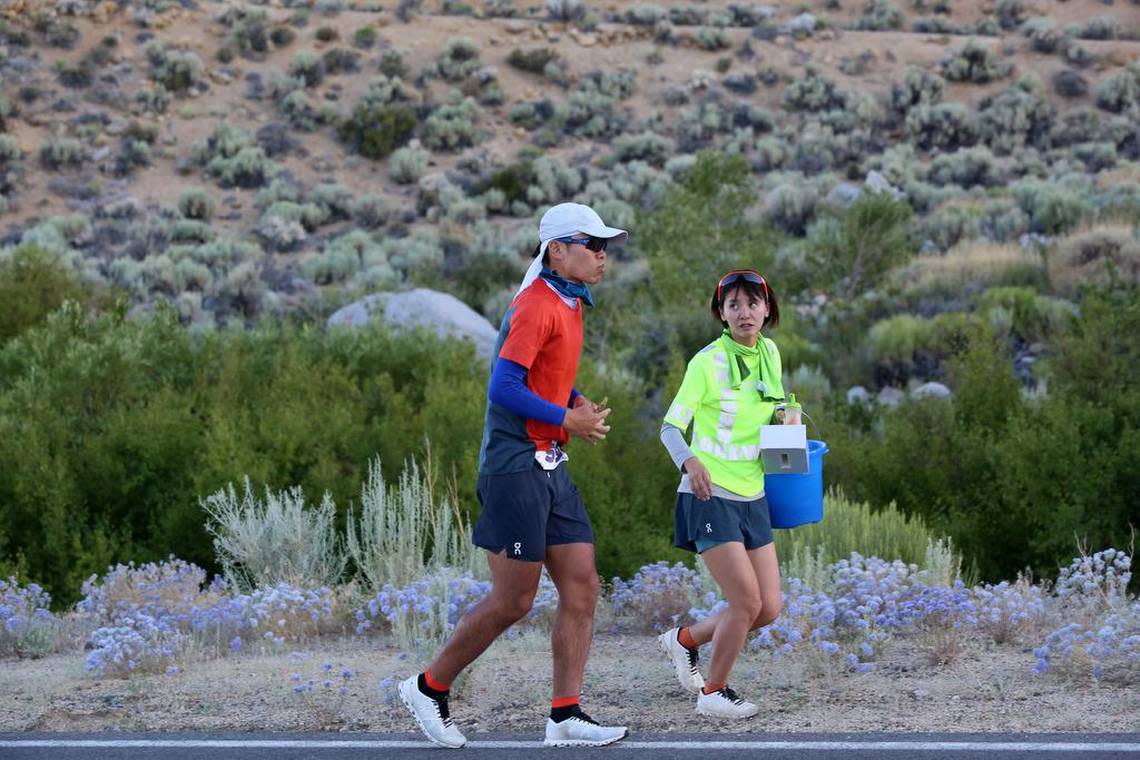 Yoshihiko Ishikawa runs while his girlfriend Miki Matsushima offers him encouragement near the Alabama Hills. Ishikawa shattered the course record.