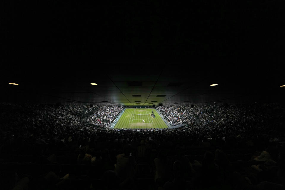 Tim van Rijthoven of the Netherlands serves to Serbia's Novak Djokovic during a men's fourth round singles match on day seven of the Wimbledon tennis championships in London, Sunday, July 3, 2022.(AP Photo/Alastair Grant)