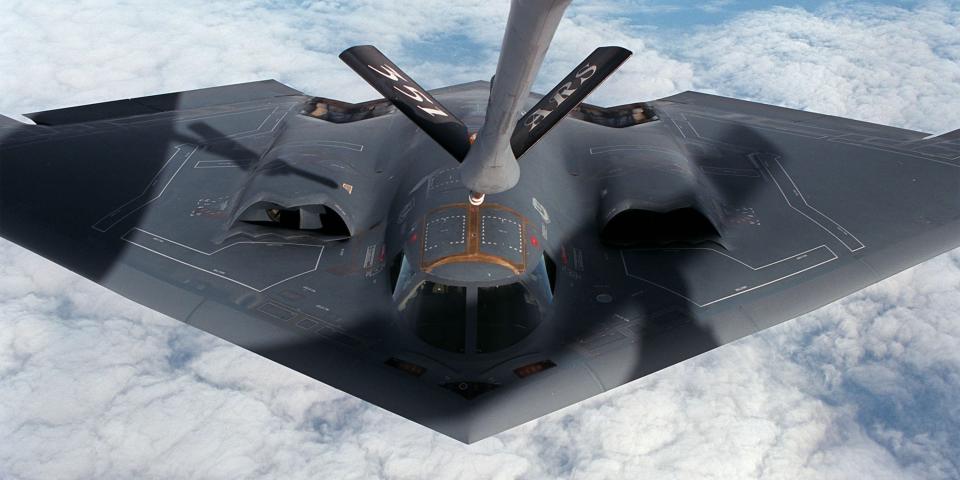 A B-2 bomber being refueled midair.