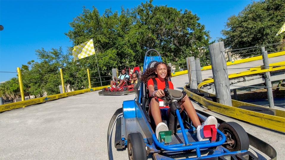 a girl riding a go kart