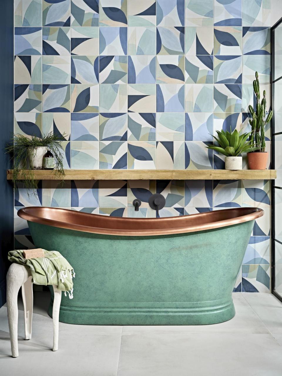 tiled bathroom with green bathtub