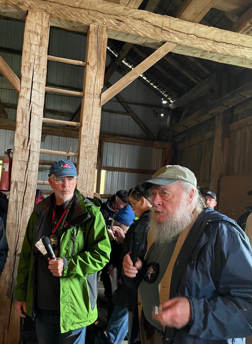 The "barn detectives" Dan Troth (left) and Rudy Christian lead about 100 people on a tour of six old barns during the Friends of Ohio Barns annual conference in Morrow County.