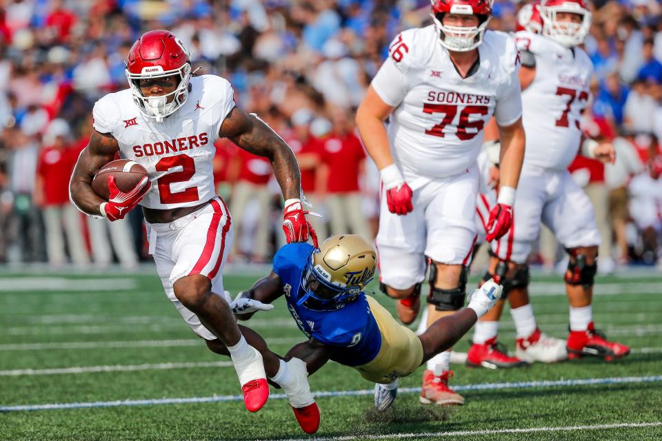 OU's Jovantae Barnes (2) eludes a tackle attempt from Tulsa’s Kanion Williams (9) in the second quarter of the Sooners' win last season at H.A. Chapman Stadium.