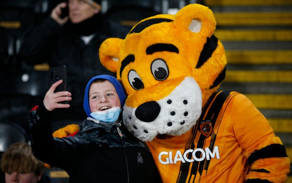 A fan poses with Roary the Tiger, the Hull City mascot - REUTERS