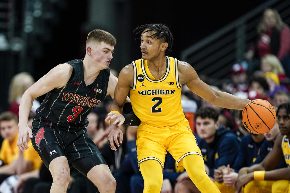 Michigan's Kobe Bufkin (2) drives against Wisconsin's Connor Essegian (3) during the second half of an NCAA college basketball game Tuesday, Feb. 14, 2023, in Madison, Wis. (AP Photo/Andy Manis)