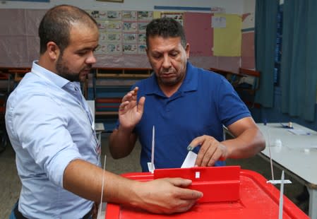 A man casts his vote at a polling station in Tunis