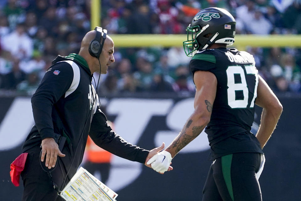 New York Jets head coach Robert Saleh congratulates New York Jets tight end C.J. Uzomah (87) after the Jets scored a touchdown against the New England Patriots during the first quarter of an NFL football game, Sunday, Oct. 30, 2022, in New York. (AP Photo/John Minchillo)