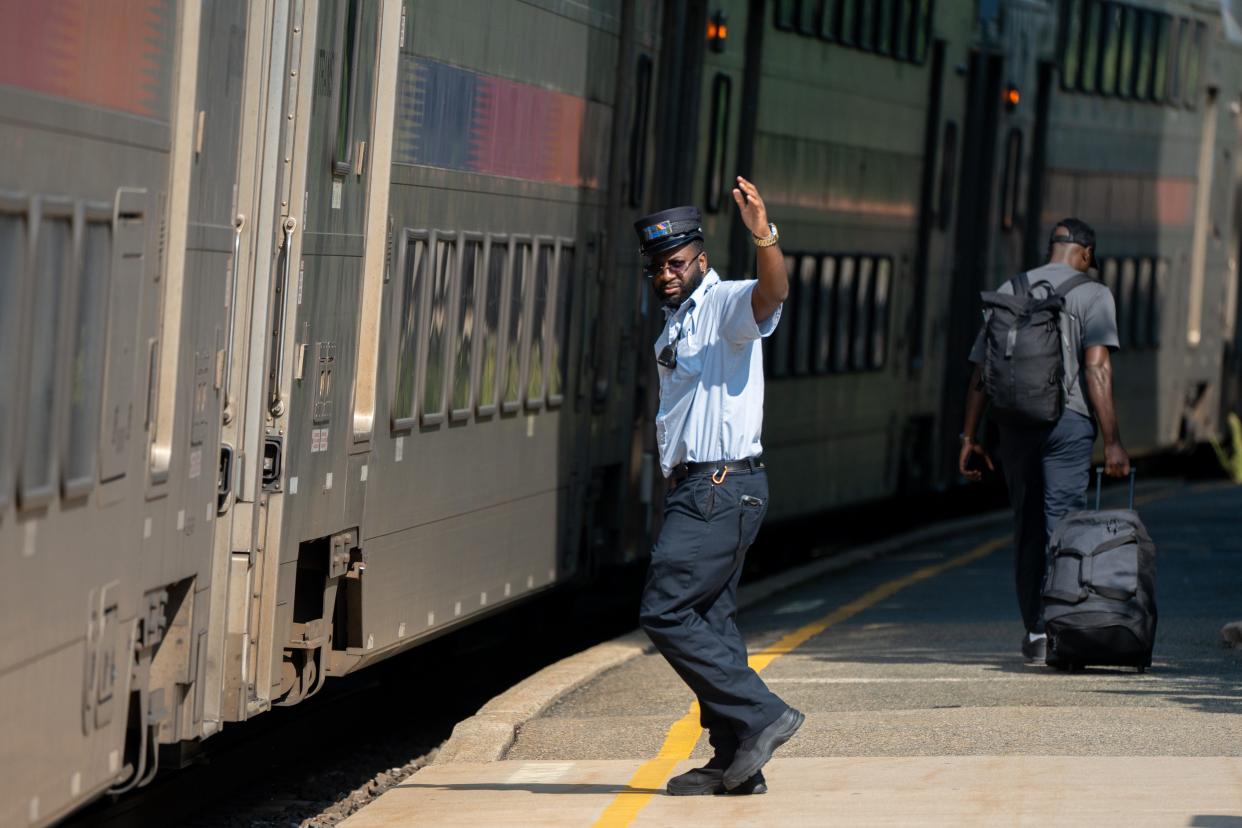 An NJ Transit worker checks the surrounding area before departing during the first day of a fare holiday at NJ Transit station in Clifton on Monday, Aug. 26, 2024. The fare holiday provides free transportation on NJ Transit from Aug. 26 through Sept. 2.