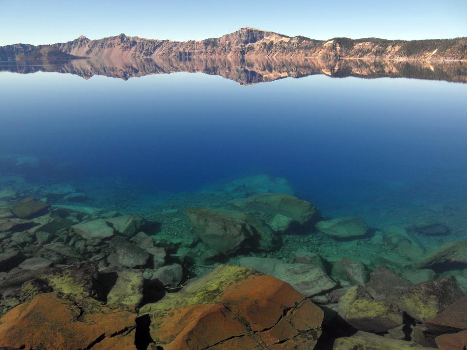 The water in Crater Lake is strikingly clear and blue.