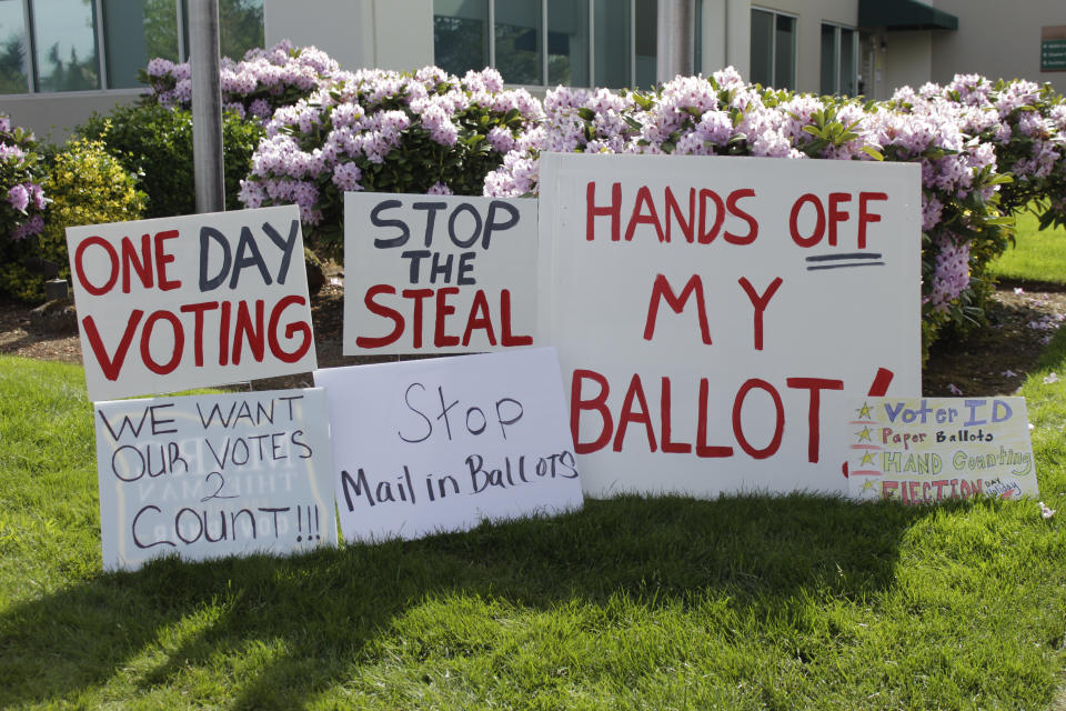 Signs criticizing election problems in Clackamas County Oregon are seen in this photo in Oregon City, Oregon, on Wednesday, May 25, 2022. Voters in an Oregon county where a ballot-printing error has delayed election results for nearly two weeks have elected the same county clerk five times in the past 20 year despite missteps that impact two previous elections and cost taxpayers $100,000. Opponents have repeatedly tried to unseat Clackamas County Clerk Sherry Hall, who was first elected in 2002, following elections errors in 2004, 2010, and 2011 and a state vote-tampering investigation in 2012.(AP Photo/Gillian Flaccus)