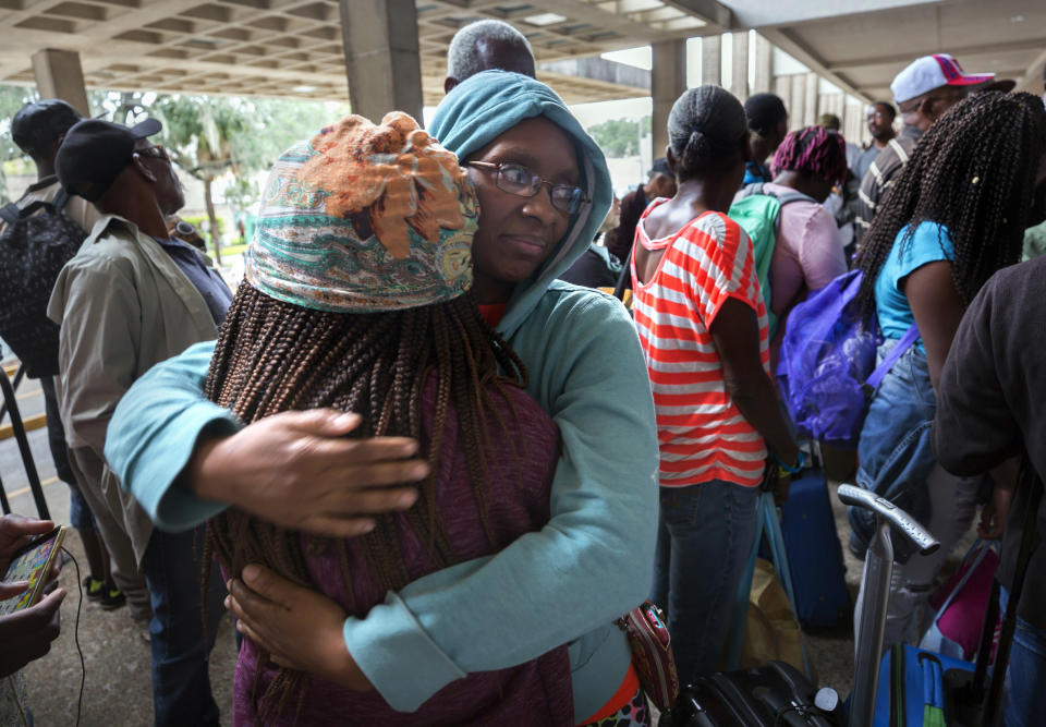 <p>Elizabeth Ponder, center, hugs her daughter Exodus Ponder, left, while standing in line at the Savannah Civic Center before evacuating from he path of Hurricane Irma, Saturday, Sept., 9, 2017 in Savannah, Ga. (Photo: Stephen B. Morton/AP) </p>