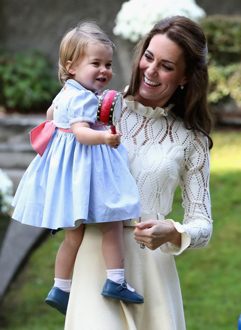 <p>Meanwhile Princess Charlotte was spending time with mom and playing with a pellet drum. The princess wore a light blue frock with a pink bow and pink buttons, and the same blue Mary Janes she had on on the first day. [Photo: Getty/Chris Jackson] </p>