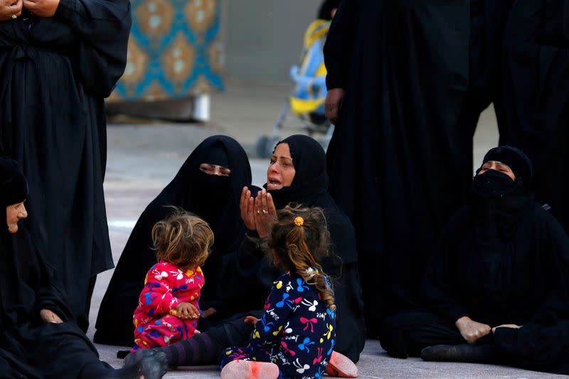 FILE PHOTO: Relatives react during a funeral of members of Kataib Hezbollah militia group, who were killed by U.S. air strikes in Qaim district, during a funeral in the holy city of Najaf