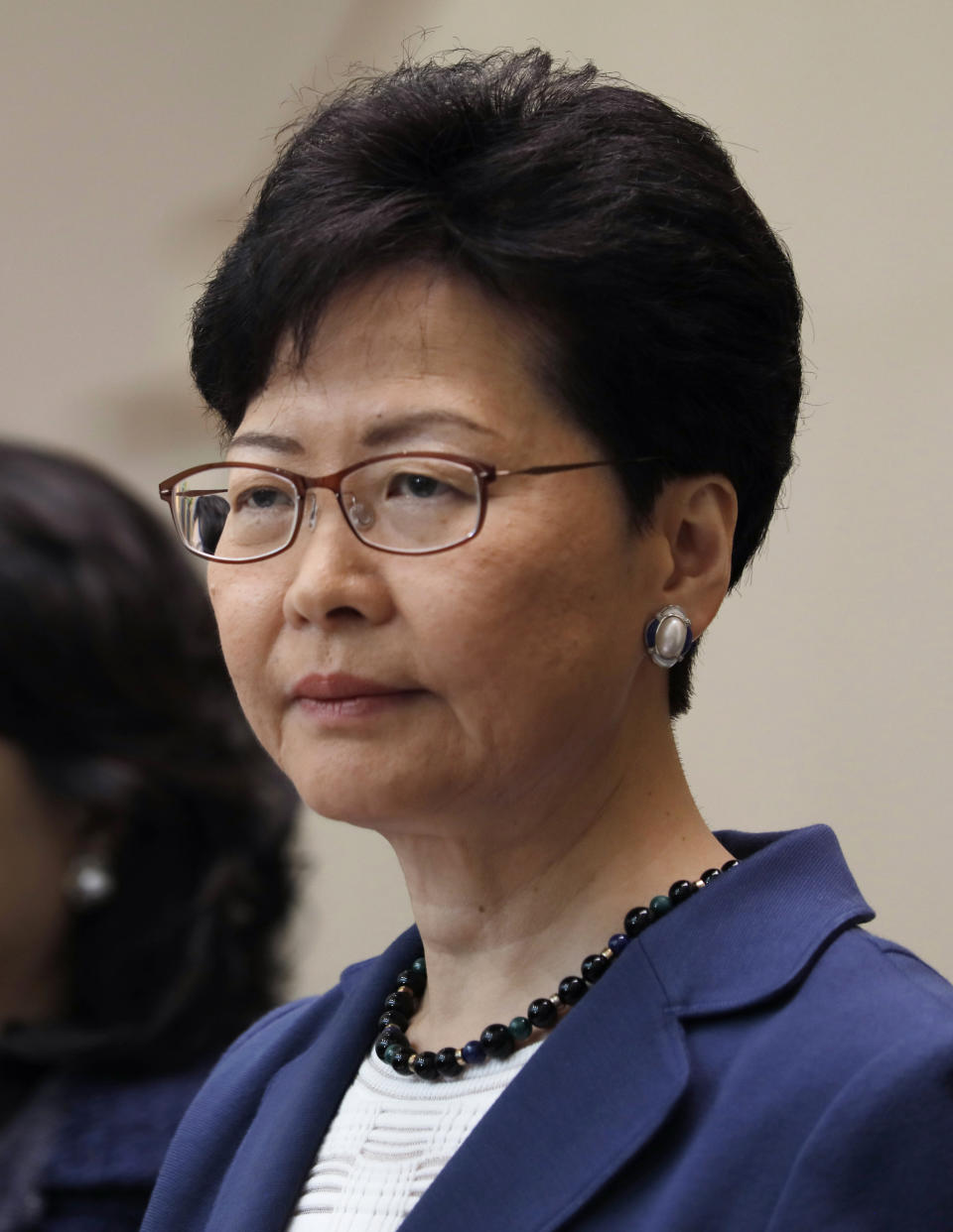 Hong Kong Chief Executive Carrie Lam listens to reporters questions during a press conference in Hong Kong Monday, June 10, 2019. Lam signaled Monday that her government will go ahead with proposed amendments to its extradition laws after a massive protest against them. (AP Photo/Vincent Yu)