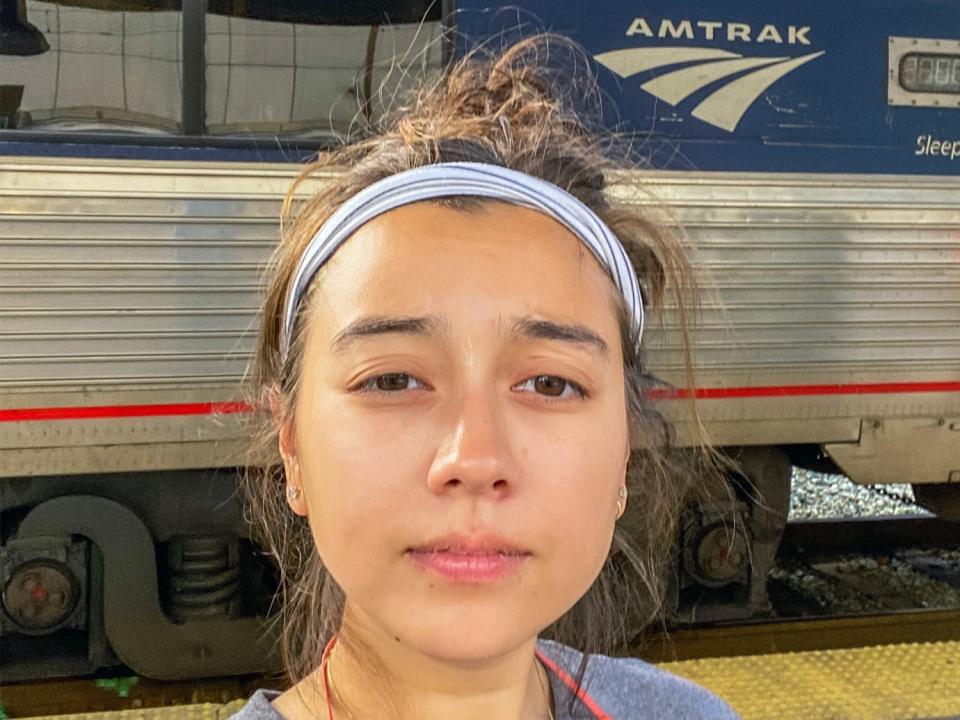 The author takes a selfie outside of (L) and inside of (R) Amtrak trains