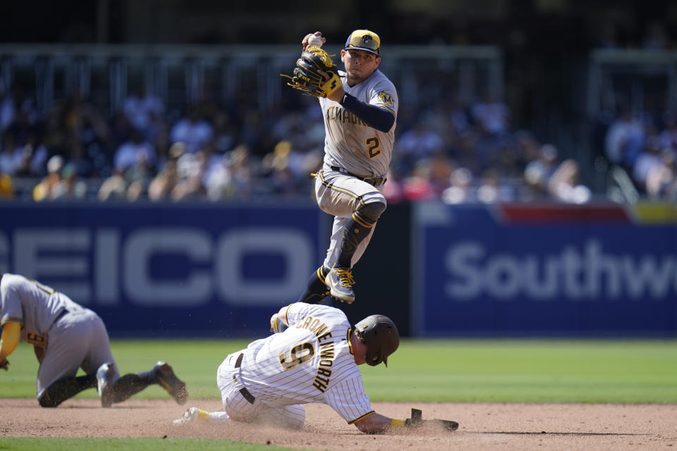 Milwaukee Brewers shortstop Luis Urias, above, hops over San Diego Padres' Jake Cronenworth, who slides into second base after being forced out during the seventh inning of a baseball game Wednesday, May 25, 2022, in San Diego. Manny Machado was safe at first on the play. (AP Photo/Gregory Bull)