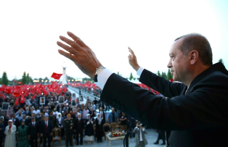 Turkish President Recep Tayyip Erdogan waves to the crowd during the opening ceremony of the July 15 Martyrs' Monument, at the Presidential Complex in Ankara, on July 16, 2017